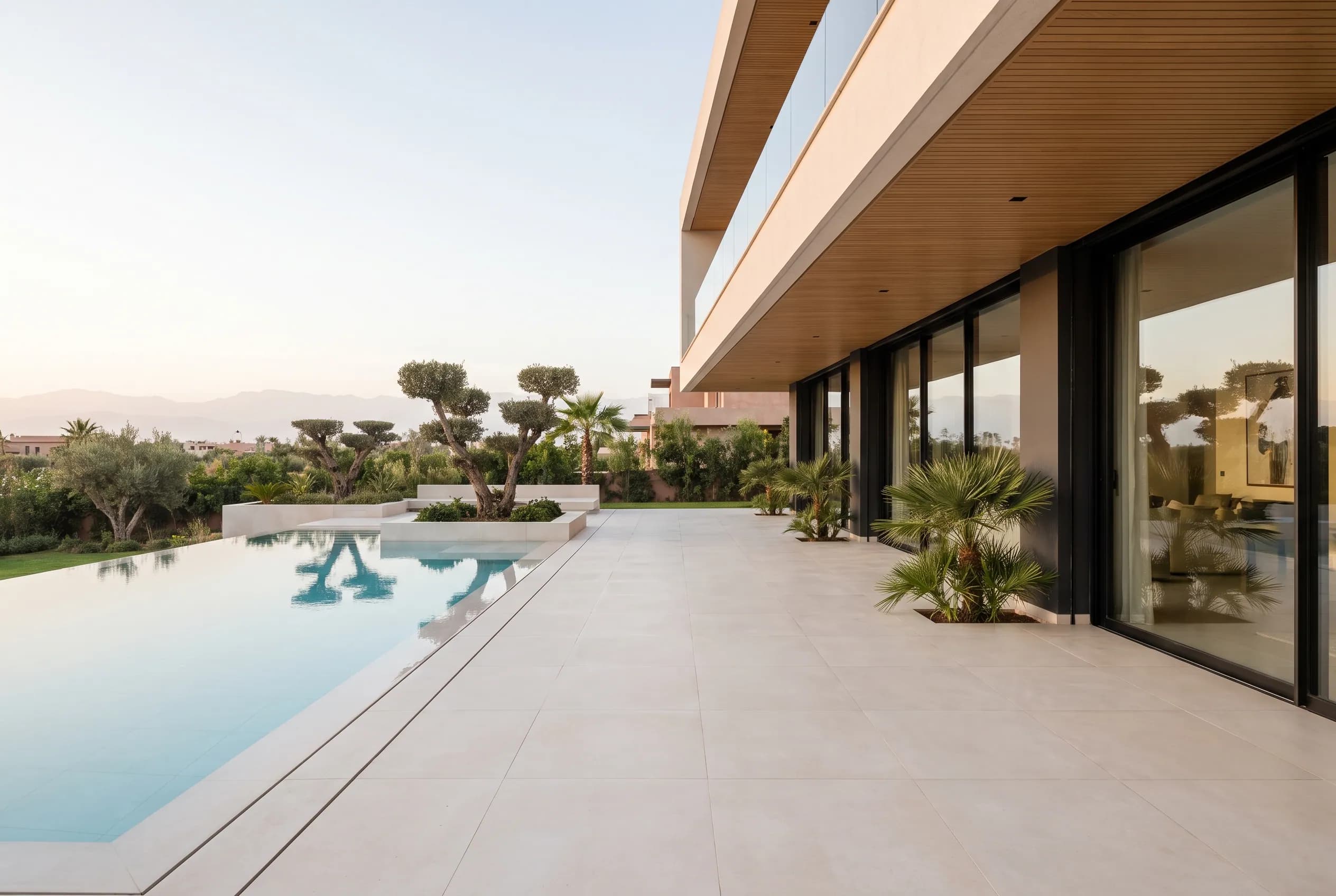 The identical view under contract — swept stone, lush planting, crystal water