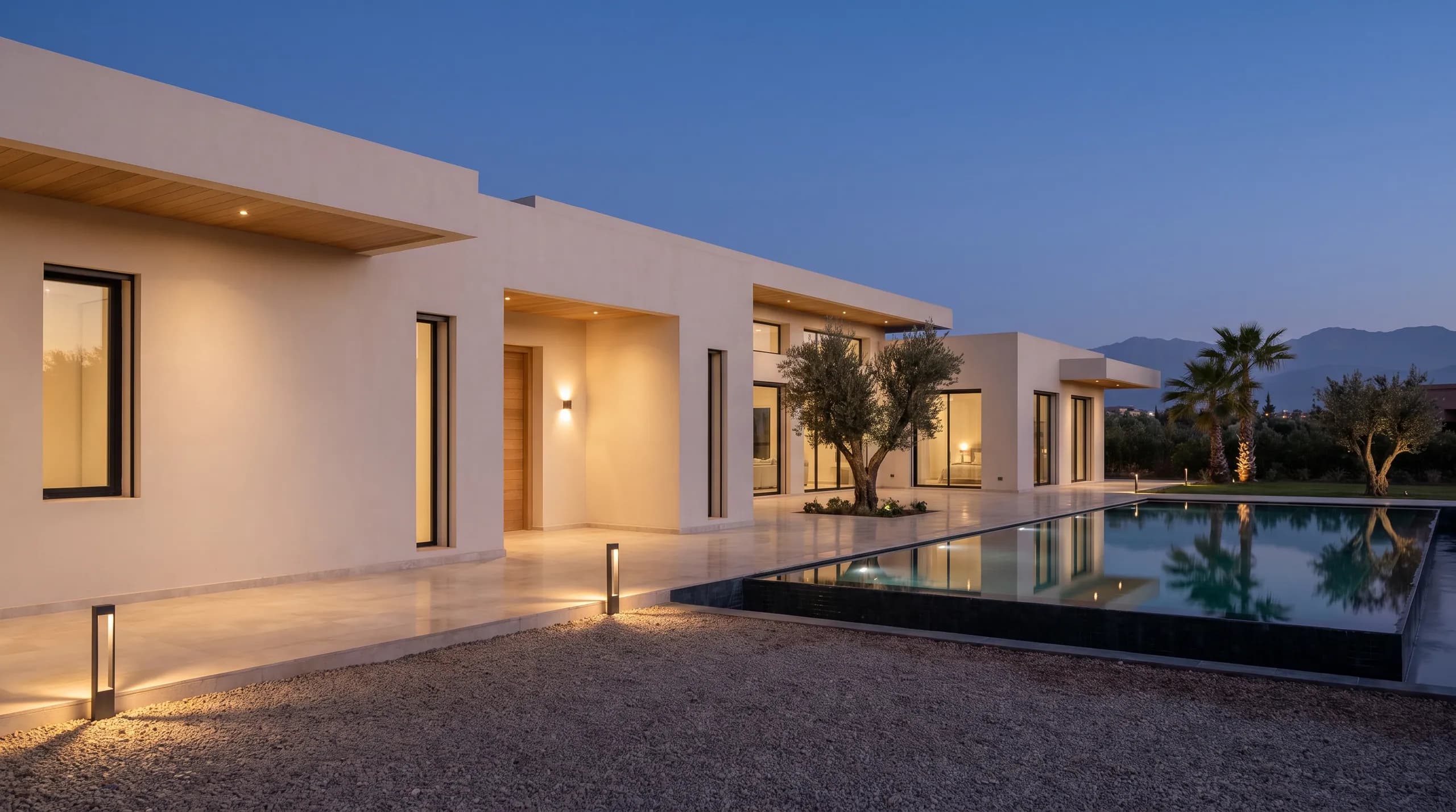 The maintained villa resting at night, entrance lamps warm